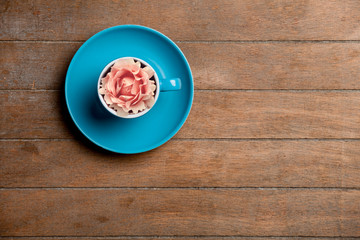 Cup of tea with rosebud in it