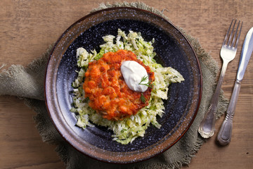 Salmon burgers nestled on a bed of coleslaw. Salmon fish cake. View from above, top