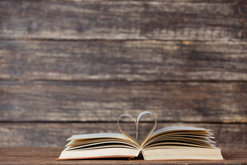 Vintage book and heart shape symbol