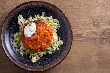 Salmon burgers nestled on a bed of coleslaw. Salmon fish cake. View from above, top