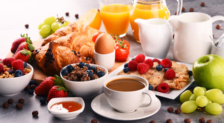 Breakfast served with coffee, juice, croissants and fruits