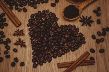 Coffee beans and ground coffee. Heart made of coffee beans. Toning.