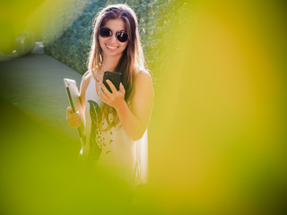 happy digital nomad girl standing outside at the pool while being on the phone