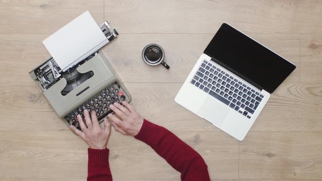 Old vs New technology. Typing on both modern computer laptop and old obsolete typewriter, contrast between modern and retro obsolete. Old and new era. 4K video, green screen