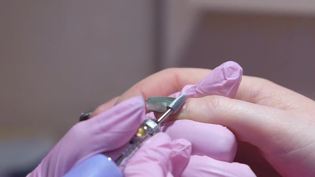 Slow motion. hardware manicure. removal of nail polish with a rotating nail file. 4k