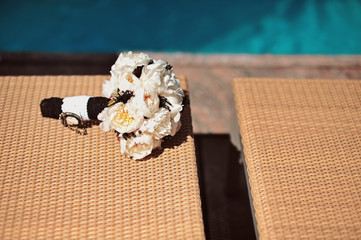 Stylish black and white Wedding bridal bouquet before wedding ceremony with decoration a lot of flowers and colorful tape shot taken by selective soft focus and macro. Swimming pool at background