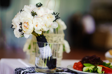 Stylish black and white Wedding bridal bouquet before wedding ceremony with decoration a lot of flowers and colorful tape shot taken by selective soft focus and macro