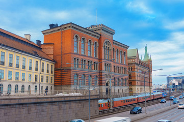 Fototapeta na wymiar Architecture Of Stockholm, Sweden. Usual street, cars, train
