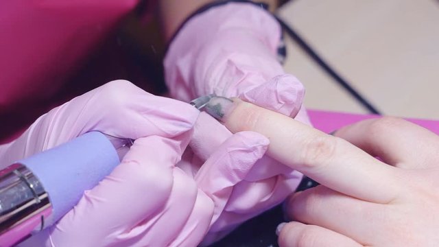 Slow motion. hardware manicure. removal of nail polish with a rotating nail file. HD