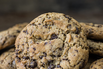 A Heap of Freshly Baked Chocolate Cookies on Rustic Wooden Table. Sweet Biscuits. Homemade pastry.