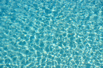 Fototapeta na wymiar Swimming pool water surface abstract background texture photo
