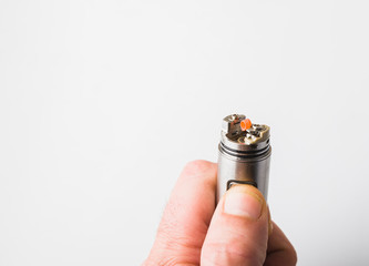 Coil burning and hand, background white