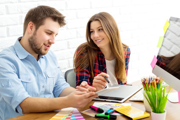 Team of creative designers working on a common project in a design studio
