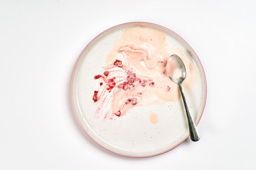 Top view of dirty plate with ice cream stains and fat