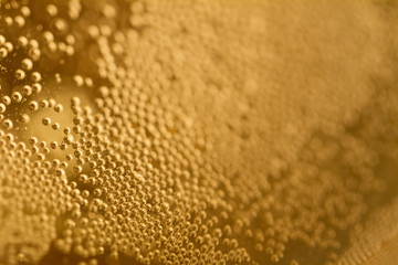 Golden bubbles inside a champagne glass © CesareFerrari
