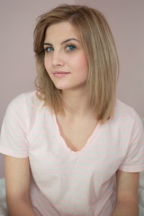 Fototapeta premium Beauty woman having fun, resting in bedroom interior white bedding background. Relaxing dream recreation time. Closeup portrait