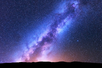 Milky Way. Space. Scenic night landscape with bright milky way, sky full of stars, orange light and...
