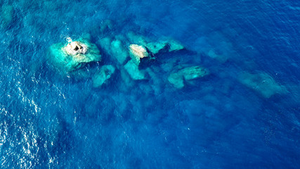 Obraz na płótnie Canvas Aerial photo rocks in clear blue sea