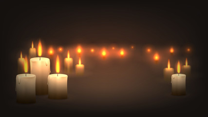 Many candles burn in the dark