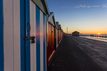 Brighton colorful beach hut beach house along the coast of Brighton Pier.