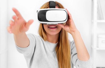 Beautiful young woman playing game in virtual reality glasses.