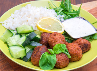 vegan dish with soymeatballs, cucumber,rice and yogurt sauce