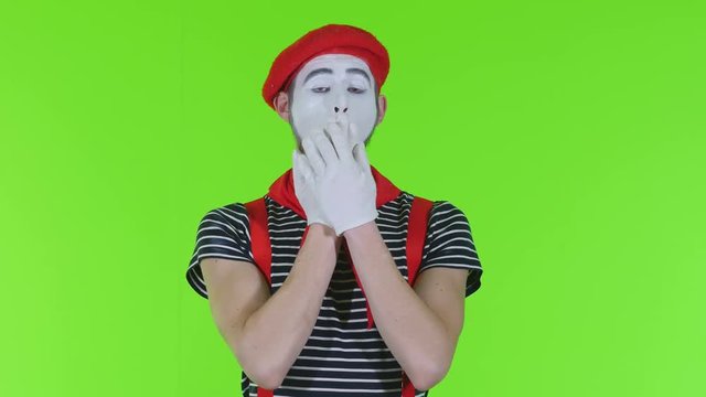Mim closes his eyes, mouth, ears on a green background