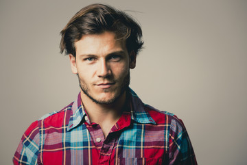 Obraz premium caucasian man wearing checkered shirt and trendy hairstyle