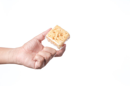 Hand holding khao soi tud, traditional Thai snack