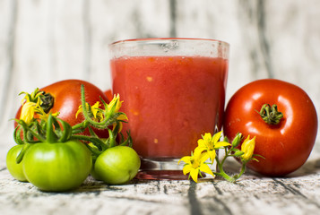 Tomato smoothie - tomato juice on wood background