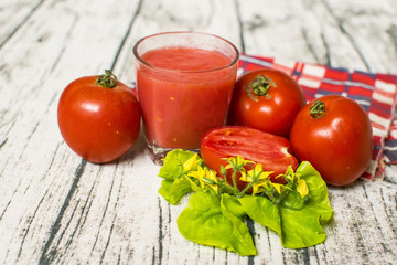 Tomato smoothie - tomato juice on wood background