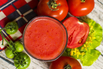 Tomato smoothie - tomato juice on wood background