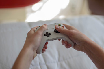 Close up of young man holding video game controller while playing video games