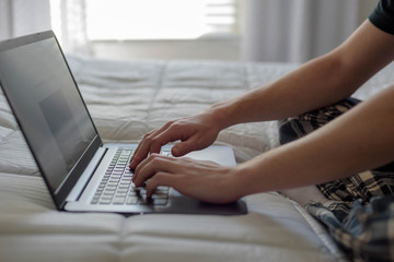 Student working on laptop in morning light