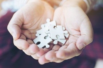 people  holding a jigsaw puzzle