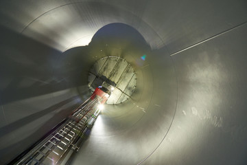 Inside the wind turbines. A wind farm is a group of wind turbines in the same location used for production of electric power.