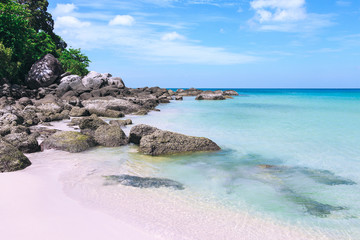 Picturesque view of Andaman sea in Phuket island, Thailand. Seascape with white sand, cliff and blue sky. Tropical beach at the exotic island.