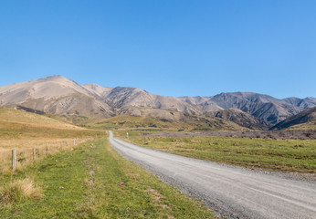 country road across barren hills in Southern Alps around Molesworth Station, South Island, New Zealand