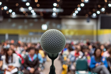 Microphone over the Abstract blurred photo of conference hall or seminar room in Exhibition Center background with Speakers on the stage and attendee background, Business meeting and education concept - 195948806