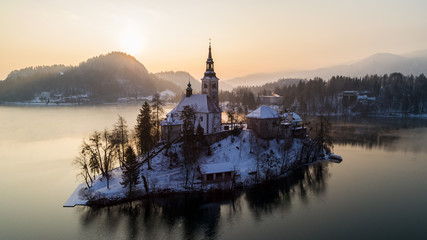 Aerial photo of beautiful Bled lake landmark with church on the island at sunrise