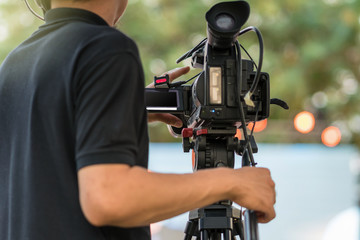 Rear side of Video Cameraman taking photograp to the stage, event and seminar production equipment concept