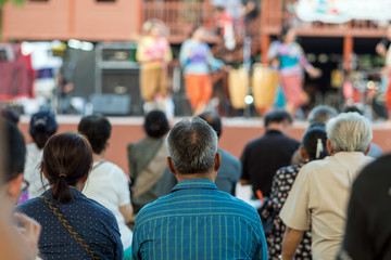 Rear side of Audiences sitting and listening the speackers on the stage, event and seminar concept