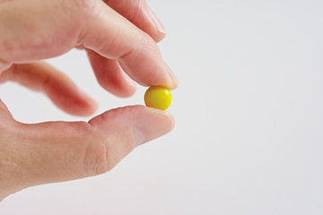 Yellow pill on a white background
