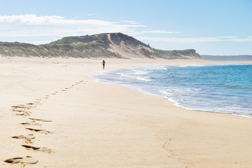 Fototapeta na wymiar Footsteps of a female runner at the beach of Peterborough at the Great Ocean Road, Victoria, Australia