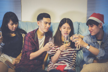 Asian group of friends having party with alcoholic beer drinks and Young people enjoying at a bar toasting cocktails.soft focus
