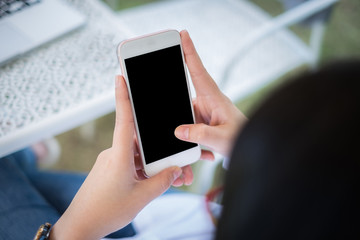 Beautiful woman using phone and application with blank screen mobile.