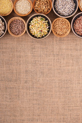 Variety of rice and grains in bowls on linen tablecloth