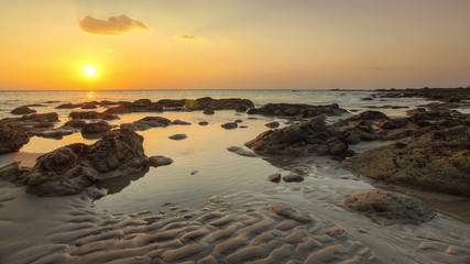 Beach in golden sunset light during low tide showing sand formations and rocks not covered by the sea. Kantiang Bay, Ko Lanta, Thailand. - obrazy, fototapety, plakaty