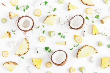 Fruit background. Pineapples and coconuts pattern on white background. Summer fruits. Flat lay, top view