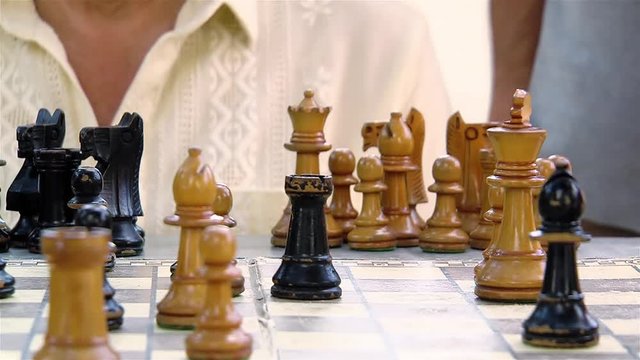 Two men play chess. 